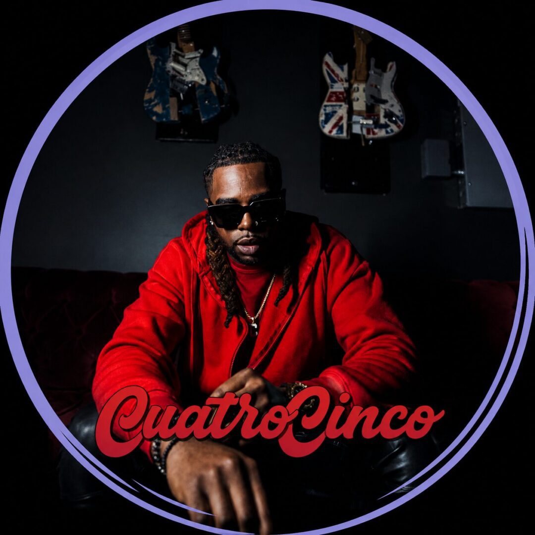 Seated man in red hoodie and sunglasses