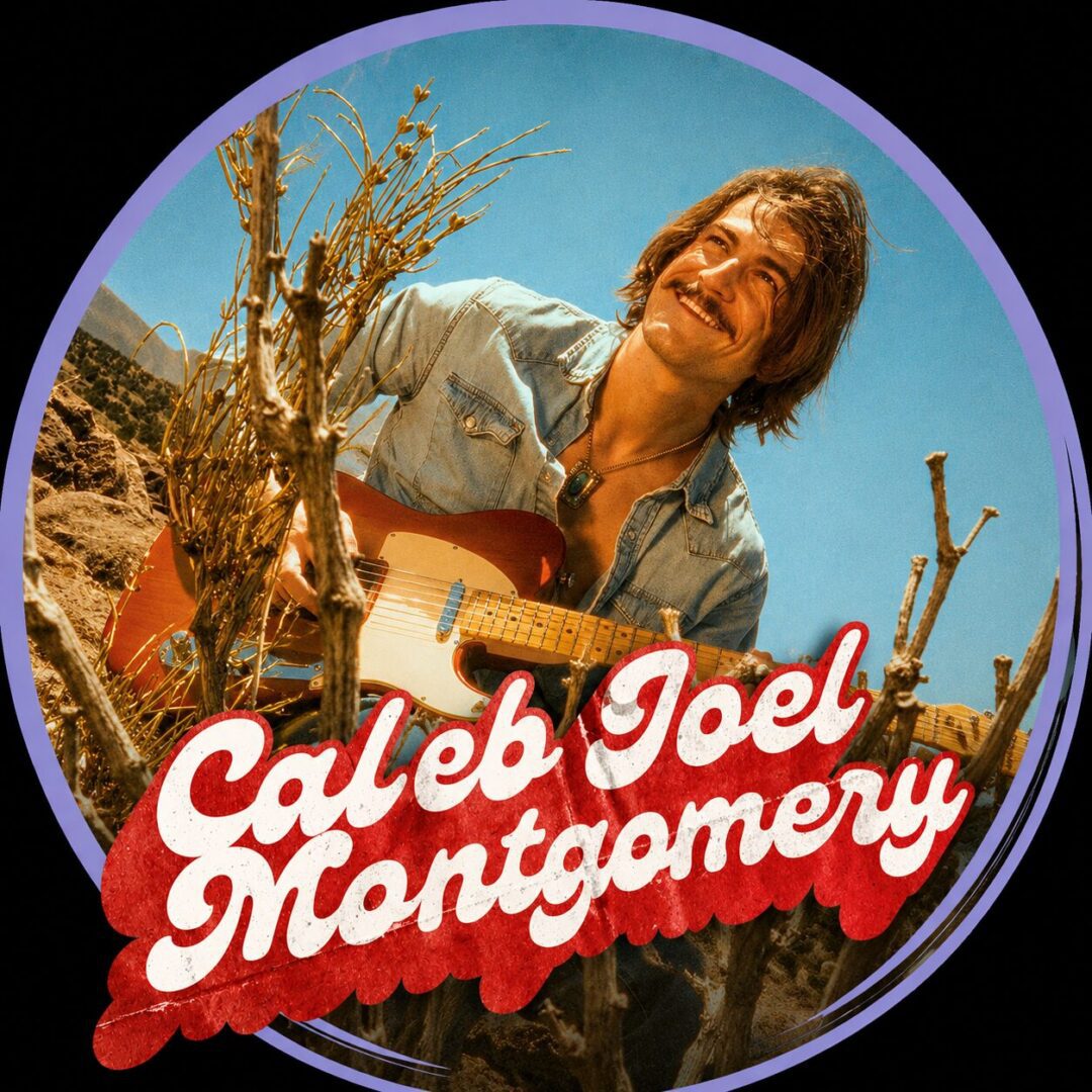 Smiling musician playing guitar in desert